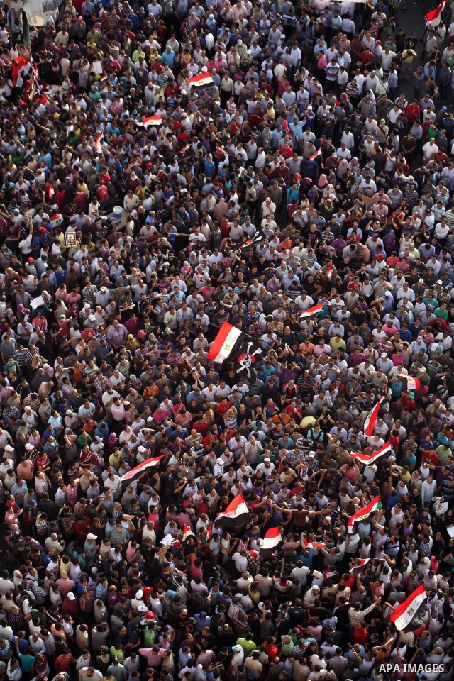 A view taken from a building overviewing Tahrir square shows Egyptian protesters shouting slogans against former President Hosni Mubarak and his aides during a demonstration hours after the announcement of the verdict in...