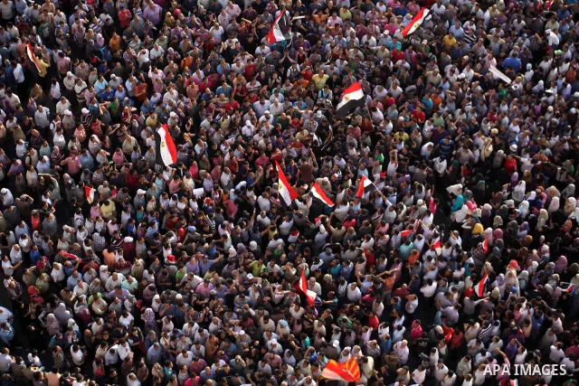 A view taken from a building overviewing Tahrir square shows Egyptian protesters shouting slogans against former President Hosni Mubarak and his aides during a demonstration hours after the announcement of the verdict in...