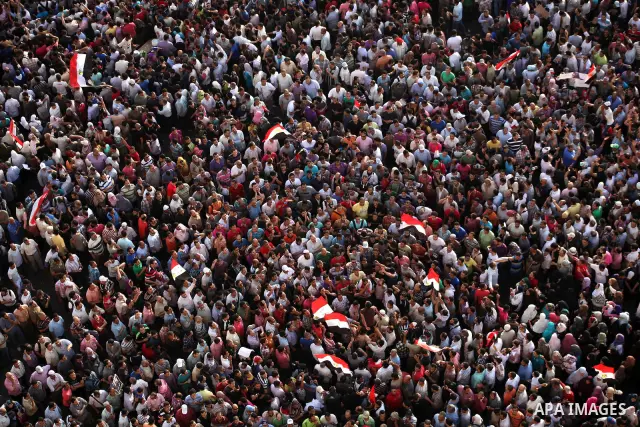 A view taken from a building overviewing Tahrir square shows Egyptian protesters shouting slogans against former President Hosni Mubarak and his aides during a demonstration hours after the announcement of the verdict in...