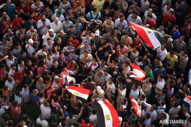 A view taken from a building overviewing Tahrir square shows Egyptian protesters shouting slogans against former President Hosni Mubarak and his aides during a demonstration hours after the announcement of the verdict in...