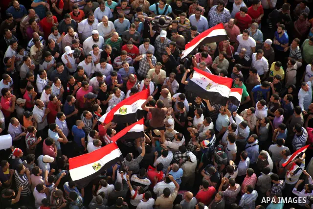 A view taken from a building overviewing Tahrir square shows Egyptian protesters shouting slogans against former President Hosni Mubarak and his aides during a demonstration hours after the announcement of the verdict in...