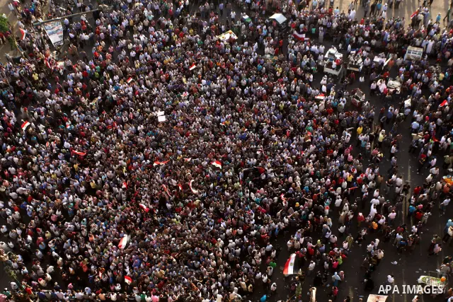 A view taken from a building overviewing Tahrir square shows Egyptian protesters shouting slogans against former President Hosni Mubarak and his aides during a demonstration hours after the announcement of the verdict in...