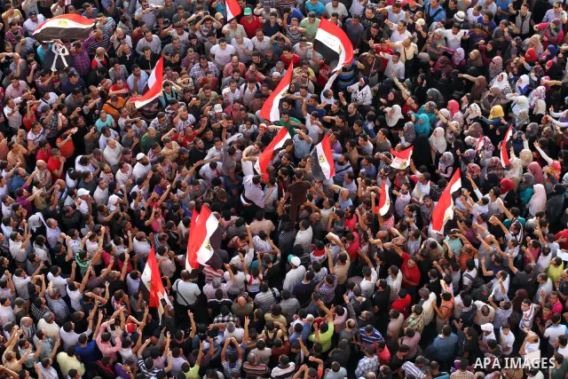 A view taken from a building overviewing Tahrir square shows Egyptian protesters shouting slogans against former President Hosni Mubarak and his aides during a demonstration hours after the announcement of the verdict in...