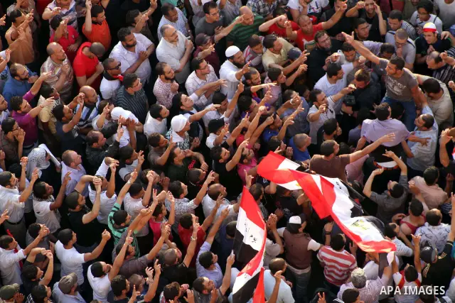 A view taken from a building overviewing Tahrir square shows Egyptian protesters shouting slogans against former President Hosni Mubarak and his aides during a demonstration hours after the announcement of the verdict in...