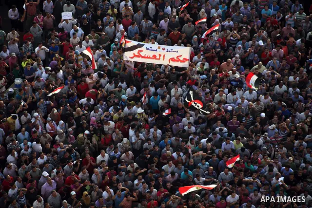 A view taken from a building overviewing Tahrir square shows Egyptian protesters shouting slogans against former President Hosni Mubarak and his aides during a demonstration hours after the announcement of the verdict in...
