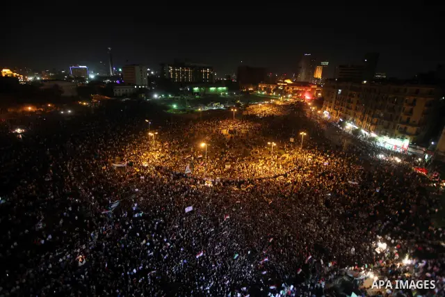 A view taken from a building overviewing Tahrir square shows Egyptian protesters shouting slogans against former President Hosni Mubarak and his aides during a demonstration hours after the announcement of the verdict in...