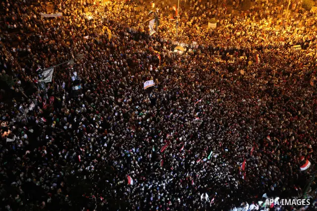 A view taken from a building overviewing Tahrir square shows Egyptian protesters shouting slogans against former President Hosni Mubarak and his aides during a demonstration hours after the announcement of the verdict in...