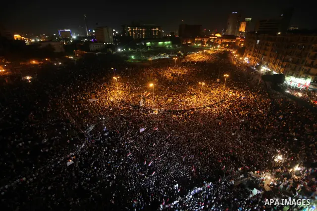 A view taken from a building over viewing Tahrir square shows Egyptian protesters shouting slogans against former President Hosni Mubarak and his aides during a demonstration hours after the announcement of the verdict i...