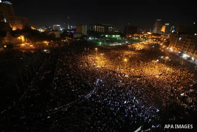 A view taken from a building over viewing Tahrir square shows Egyptian protesters shouting slogans against former President Hosni Mubarak and his aides during a demonstration hours after the announcement of the verdict i...