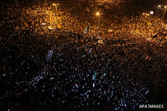 A view taken from a building over viewing Tahrir square shows Egyptian protesters shouting slogans against former President Hosni Mubarak and his aides during a demonstration hours after the announcement of the verdict i...