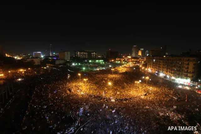 A view taken from a building over viewing Tahrir square shows Egyptian protesters shouting slogans against former President Hosni Mubarak and his aides during a demonstration hours after the announcement of the verdict i...