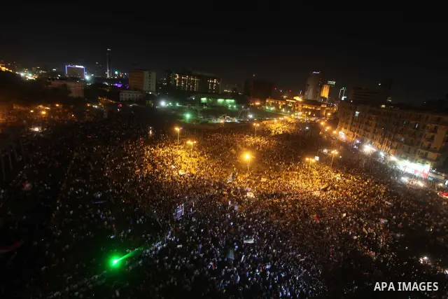 A view taken from a building over viewing Tahrir square shows Egyptian protesters shouting slogans against former President Hosni Mubarak and his aides during a demonstration hours after the announcement of the verdict i...