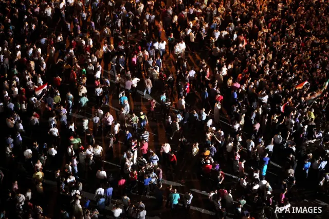 A view taken from a building over viewing Tahrir square shows Egyptian protesters shouting slogans against former President Hosni Mubarak and his aides during a demonstration hours after the announcement of the verdict i...
