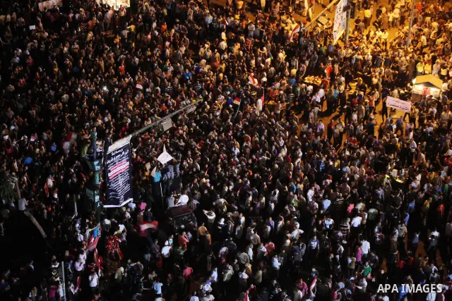 A view taken from a building over viewing Tahrir square shows Egyptian protesters shouting slogans against former President Hosni Mubarak and his aides during a demonstration hours after the announcement of the verdict i...