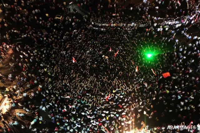A view taken from a building over viewing Tahrir square shows Egyptian protesters shouting slogans against former President Hosni Mubarak and his aides during a demonstration hours after the announcement of the verdict i...