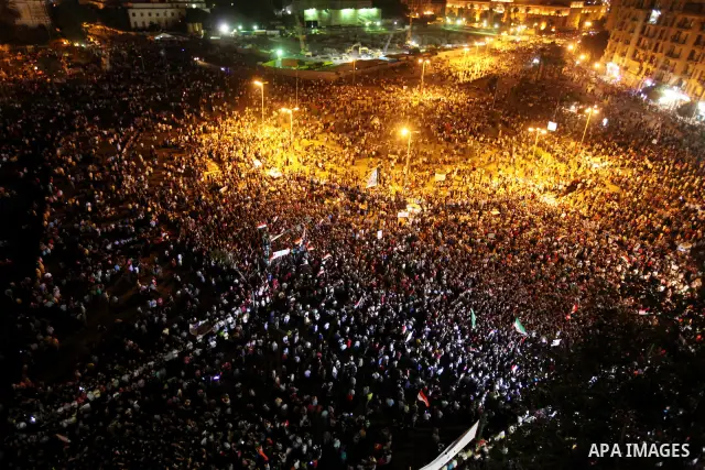 A view taken from a building over viewing Tahrir square shows Egyptian protesters shouting slogans against former President Hosni Mubarak and his aides during a demonstration hours after the announcement of the verdict i...