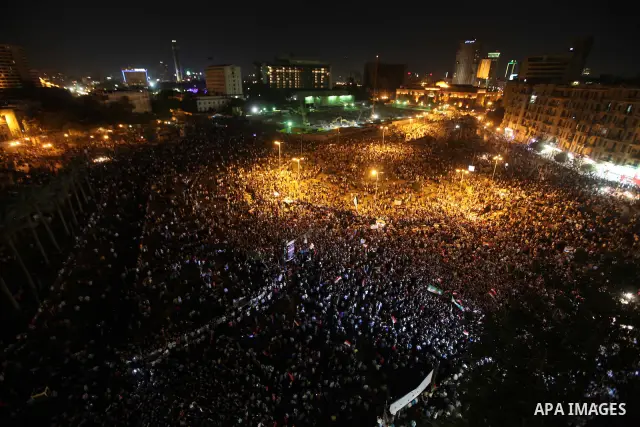 A view taken from a building over viewing Tahrir square shows Egyptian protesters shouting slogans against former President Hosni Mubarak and his aides during a demonstration hours after the announcement of the verdict i...