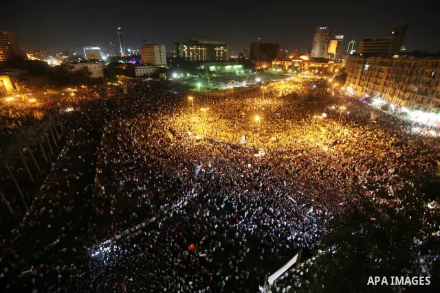 A view taken from a building over viewing Tahrir square shows Egyptian protesters shouting slogans against former President Hosni Mubarak and his aides during a demonstration hours after the announcement of the verdict i...