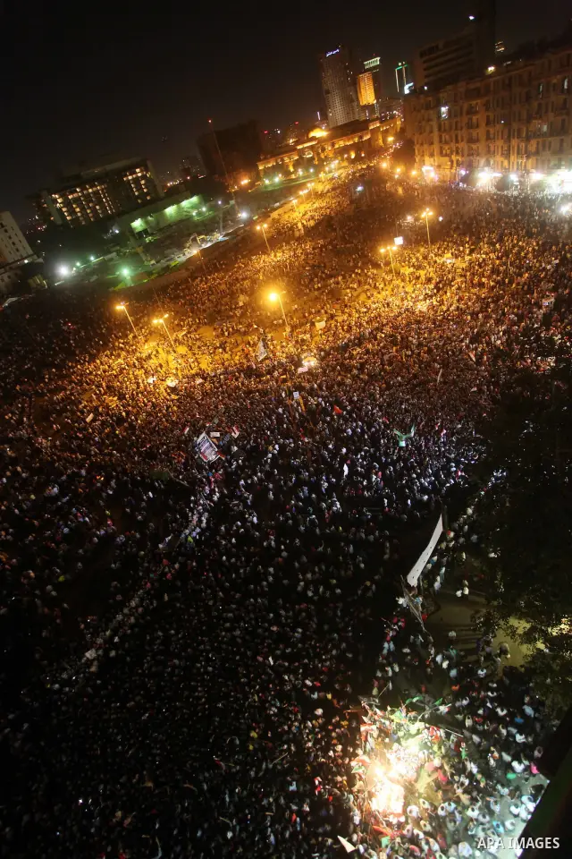 A view taken from a building over viewing Tahrir square shows Egyptian protesters shouting slogans against former President Hosni Mubarak and his aides during a demonstration hours after the announcement of the verdict i...