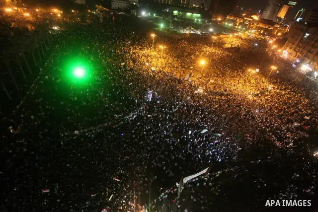 A view taken from a building over viewing Tahrir square shows Egyptian protesters shouting slogans against former President Hosni Mubarak and his aides during a demonstration hours after the announcement of the verdict i...