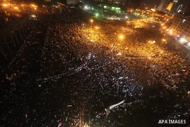 A view taken from a building over viewing Tahrir square shows Egyptian protesters shouting slogans against former President Hosni Mubarak and his aides during a demonstration hours after the announcement of the verdict i...