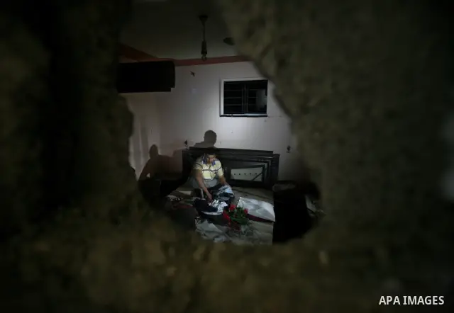 A Palestinian man inspects a destroyed house after an Israeli missile strike in Al-Nussirat Refugee Camp in central Gaza Strip, 03 June 2012. According to news reports, seven Palestinians were wounded in a series of Isra...