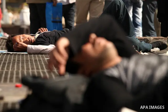 Egyptian men sleep on the ground in Cairo's landmark Tahrir Square on June 3, 2012 after a night of protests. Hundreds of demonstrators are occupying Tahrir Square after a court sentenced ousted president Hosni Mubarak a...