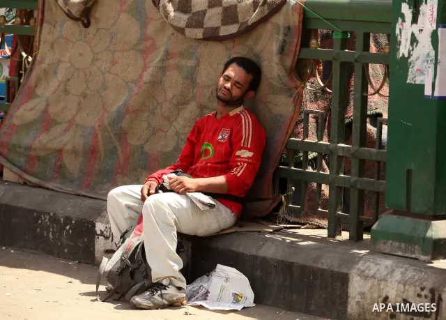 An Egyptian man sleeps on the ground in Cairo's landmark Tahrir Square on June 3, 2012 after a night of protests. Hundreds of demonstrators are occupying Tahrir Square after a court sentenced ousted president Hosni Mubar...