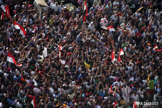Egyptian preacher and member of the Muslim Brotherhood Safwat el-Hegazy is carried up by protesters as he joins them in a demonstration a day after a court sentenced deposed president Hosni Mubarak to life in prison, at...