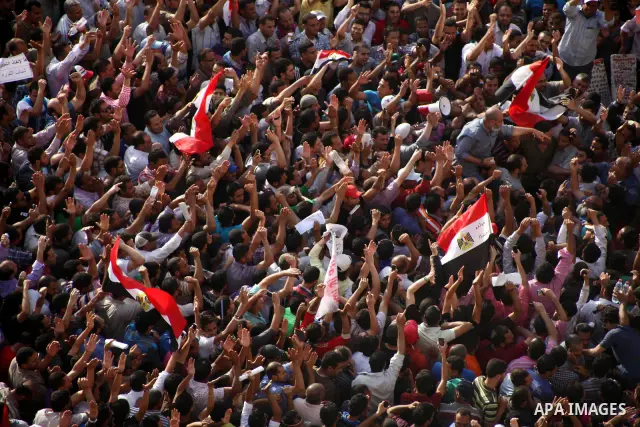 Egyptian preacher and member of the Muslim Brotherhood Safwat el-Hegazy is carried up by protesters as he joins them in a demonstration a day after a court sentenced deposed president Hosni Mubarak to life in prison, at...