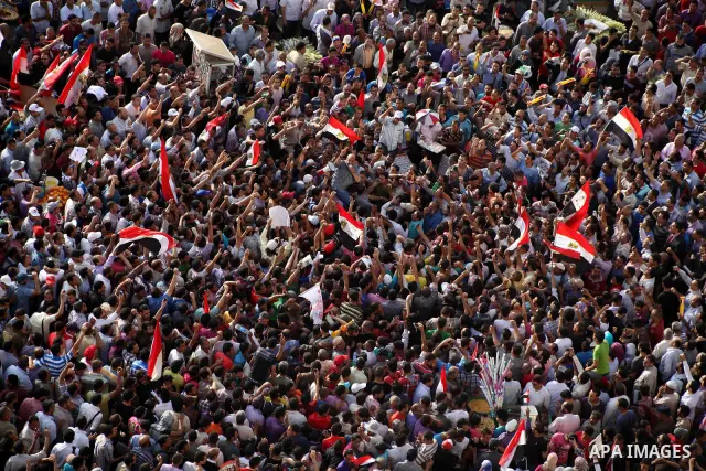 Egyptian preacher and member of the Muslim Brotherhood Safwat el-Hegazy is carried up by protesters as he joins them in a demonstration a day after a court sentenced deposed president Hosni Mubarak to life in prison, at...
