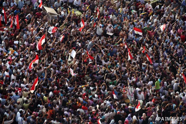 Egyptian preacher and member of the Muslim Brotherhood Safwat el-Hegazy is carried up by protesters as he joins them in a demonstration a day after a court sentenced deposed president Hosni Mubarak to life in prison, at...