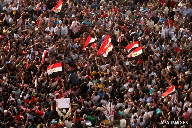 Egyptian preacher and member of the Muslim Brotherhood Safwat el-Hegazy is carried up by protesters as he joins them in a demonstration a day after a court sentenced deposed president Hosni Mubarak to life in prison, at...