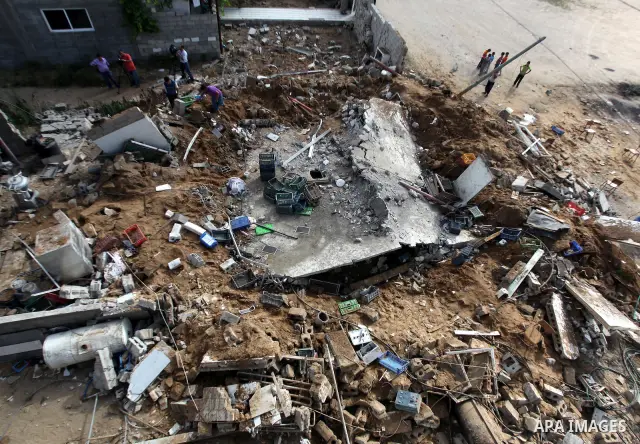 Palestinian boys inspect the damage at a cheese factory in Gaza City on June 4, 2012 following an Israeli air strike on the Gaza Strip on June 3. Emergency medical sources in Gaza said seven Palestinians were wounded in...