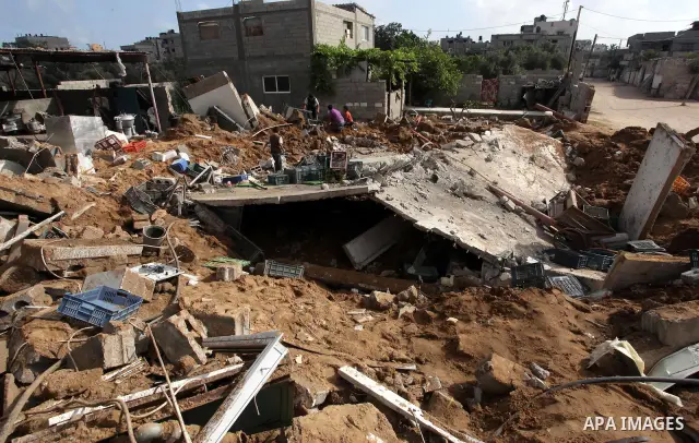 Palestinian boys inspect the damage at a cheese factory in Gaza City on June 4, 2012 following an Israeli air strike on the Gaza Strip on June 3. Emergency medical sources in Gaza said seven Palestinians were wounded in...