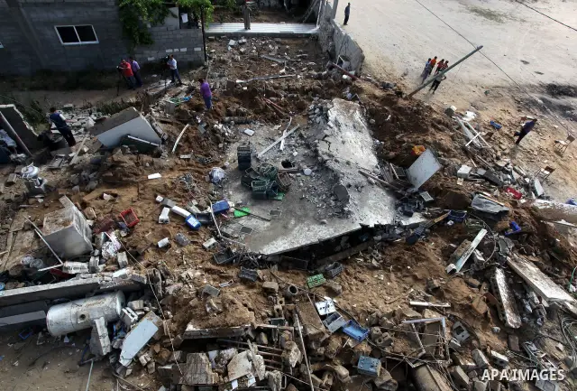 Palestinian boys inspect the damage at a cheese factory in Gaza City on June 4, 2012 following an Israeli air strike on the Gaza Strip on June 3. Emergency medical sources in Gaza said seven Palestinians were wounded in...