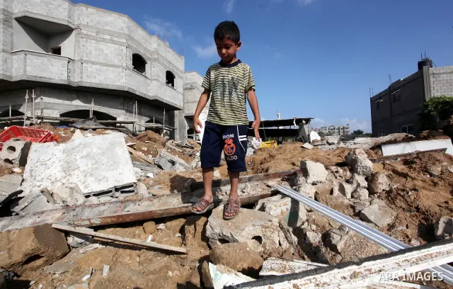 A Palestinian boy inspects the damage at a cheese factory in Gaza City on June 4, 2012 following an Israeli air strike on the Gaza Strip on June 3. Emergency medical sources in Gaza said seven Palestinians were wounded i...