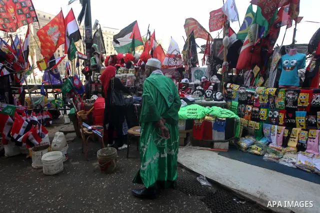 A vendor stands next to flags of Arab countries at his stall, during a sit-in at Tahrir Square after a court sentenced deposed president Hosni Mubarak to life in prison in Cairo June 4, 2012. Egyptian pro-democracy campa...