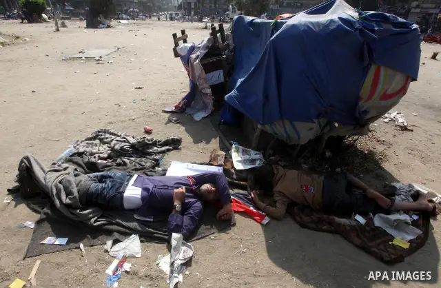 Egyptians sleep during a sit-in at Tahrir Square, after a court sentenced deposed president Hosni Mubarak to life in prison, in Cairo June 4, 2012. Thousands of Egyptians have taken to the streets in protest at the verdi...