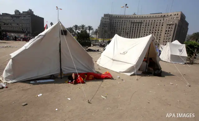 Egyptians sleep during a sit-in at Tahrir Square, after a court sentenced deposed president Hosni Mubarak to life in prison, in Cairo June 4, 2012. Thousands of Egyptians have taken to the streets in protest at the verdi...