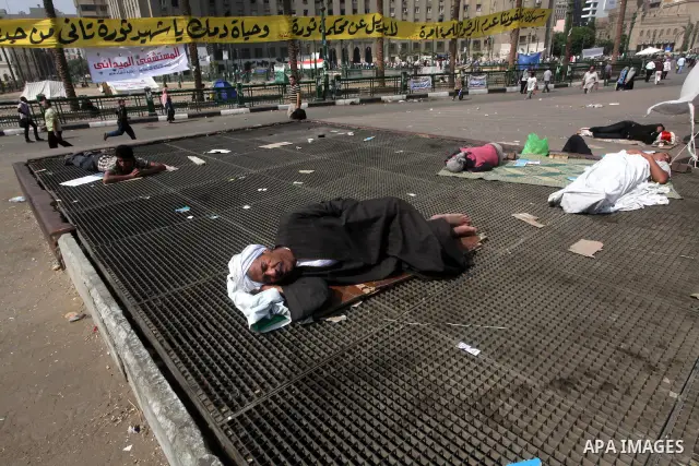 Egyptians sleep during a sit-in at Tahrir Square, after a court sentenced deposed president Hosni Mubarak to life in prison, in Cairo June 4, 2012. Thousands of Egyptians have taken to the streets in protest at the verdi...