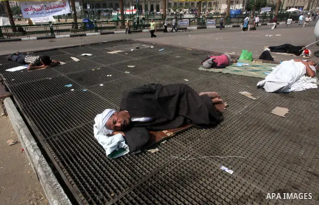 Egyptians sleep during a sit-in at Tahrir Square, after a court sentenced deposed president Hosni Mubarak to life in prison, in Cairo June 4, 2012. Thousands of Egyptians have taken to the streets in protest at the verdi...