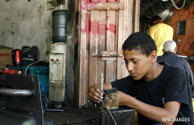 A Palestinian man fixes a generator at a shop in Rafah in the southern Gaza Strip, on June 04, 2012. The people of the Gaza Strip use a large number of generators because of the continuing lack of electricity in the Gaza...