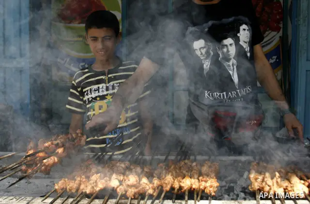 A Palestinian vendor sells grilled meat "Shish Taouk" in his shop at a market in Rafah in the southern Gaza Strip, on June, 04, 2012. Photo by Eyad Al Baba