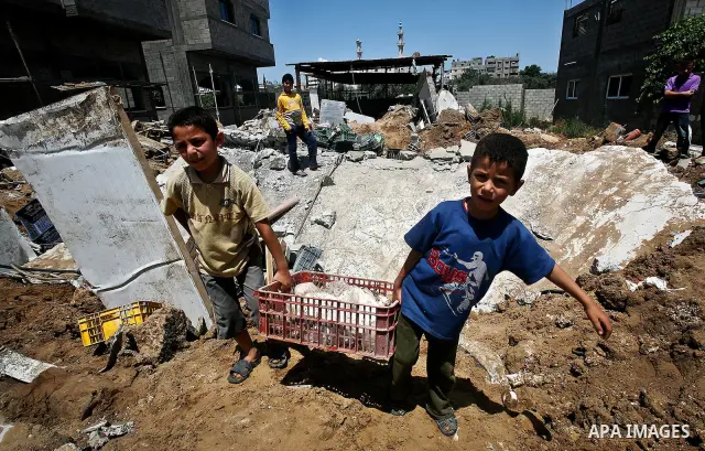 Palestinian boys inspect the damage at a cheese factory in Gaza City on June 4, 2012 following an Israeli air strike on the Gaza Strip on June 3. Emergency medical sources in Gaza said seven Palestinians were wounded in...