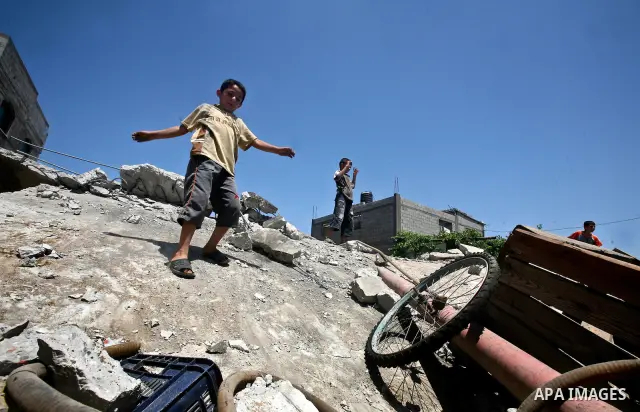 Palestinian boys inspect the damage at a cheese factory in Gaza City on June 4, 2012 following an Israeli air strike on the Gaza Strip on June 3. Emergency medical sources in Gaza said seven Palestinians were wounded in...