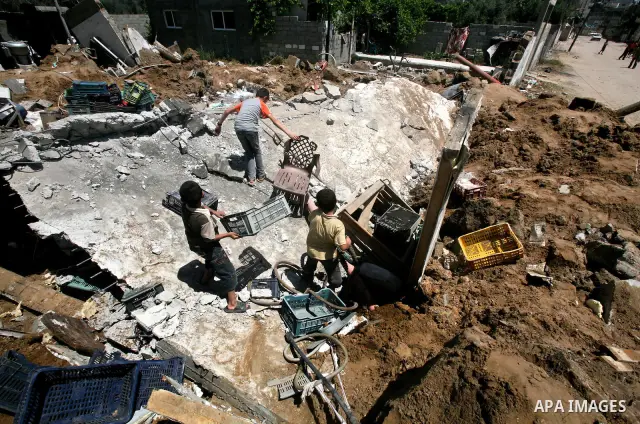 Palestinian boys inspect the damage at a cheese factory in Gaza City on June 4, 2012 following an Israeli air strike on the Gaza Strip on June 3. Emergency medical sources in Gaza said seven Palestinians were wounded in...
