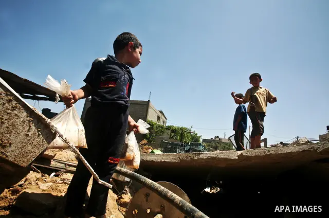 Palestinian boys inspect the damage at a cheese factory in Gaza City on June 4, 2012 following an Israeli air strike on the Gaza Strip on June 3. Emergency medical sources in Gaza said seven Palestinians were wounded in...