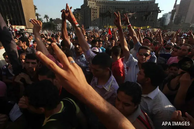 Protesters wave Egypt's flags during a demonstration at Tahrir square in Cairo, against the verdict for deposed leader Hosni Mubarak June 4, 2012. Egyptian pro-democracy campaigners called on Sunday for a new uprising, s...