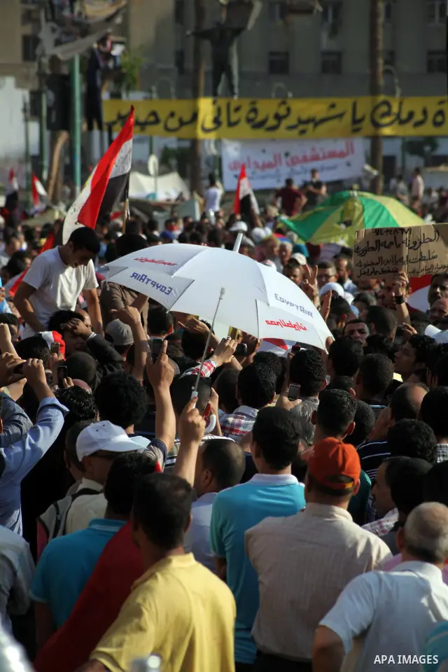 Protesters wave Egypt's flags during a demonstration at Tahrir square in Cairo, against the verdict for deposed leader Hosni Mubarak June 4, 2012. Egyptian pro-democracy campaigners called on Sunday for a new uprising, s...